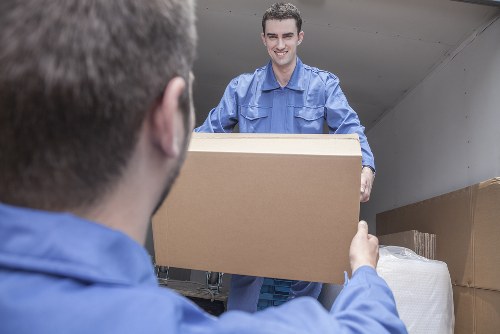 Professional movers handling furniture during the move in Queens Park